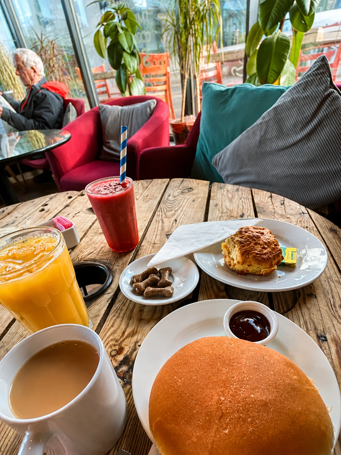Smoothie, tea, coffee and breakfast at a cafe table