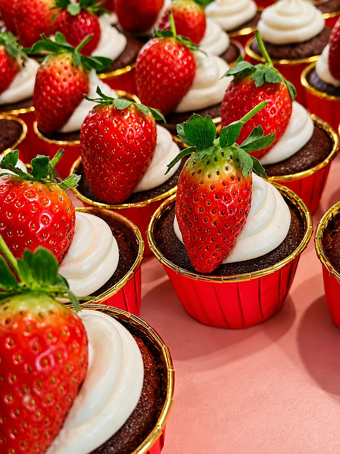Chocolate cupcakes with strawberries and cream