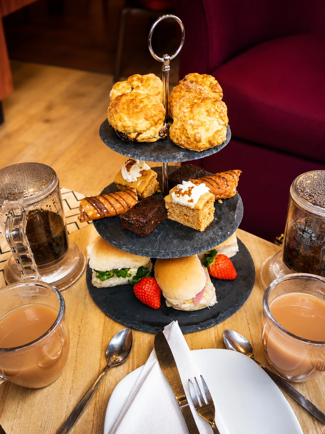 Tiered pastry stand with scones, cakes and tea