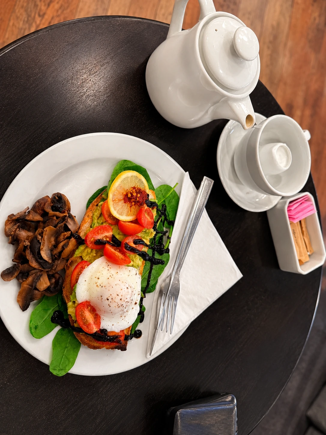 Avocado toast with egg, tomatoes and mushrooms